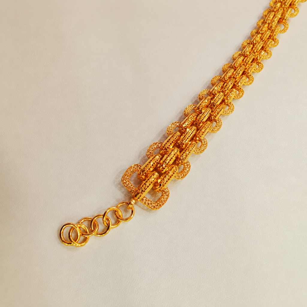 Detail of the 916 gold double-link bracelet textured links and adjustable extension rings