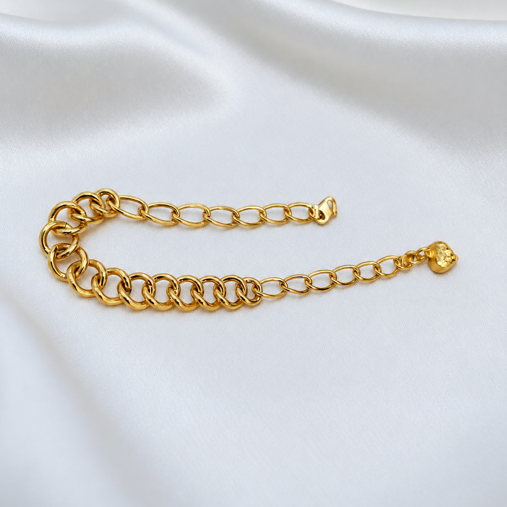 916 gold dual design link bracelet BR25199 folded in a U shape on white satin