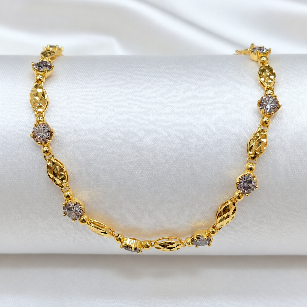 Guild Bullion BR7036 916 gold bracelet with faceted oval links and round silver-coloured accents on a white display