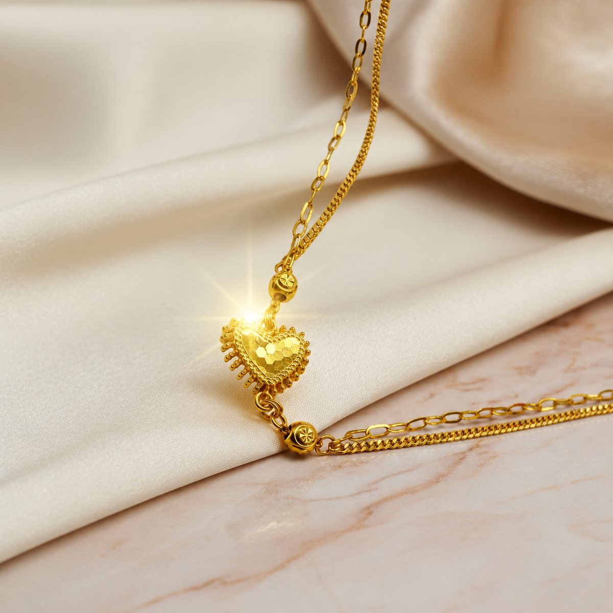 Close-up of the textured heart and small bead details on the 916 gold Elegant Heart and Bead Bracelet