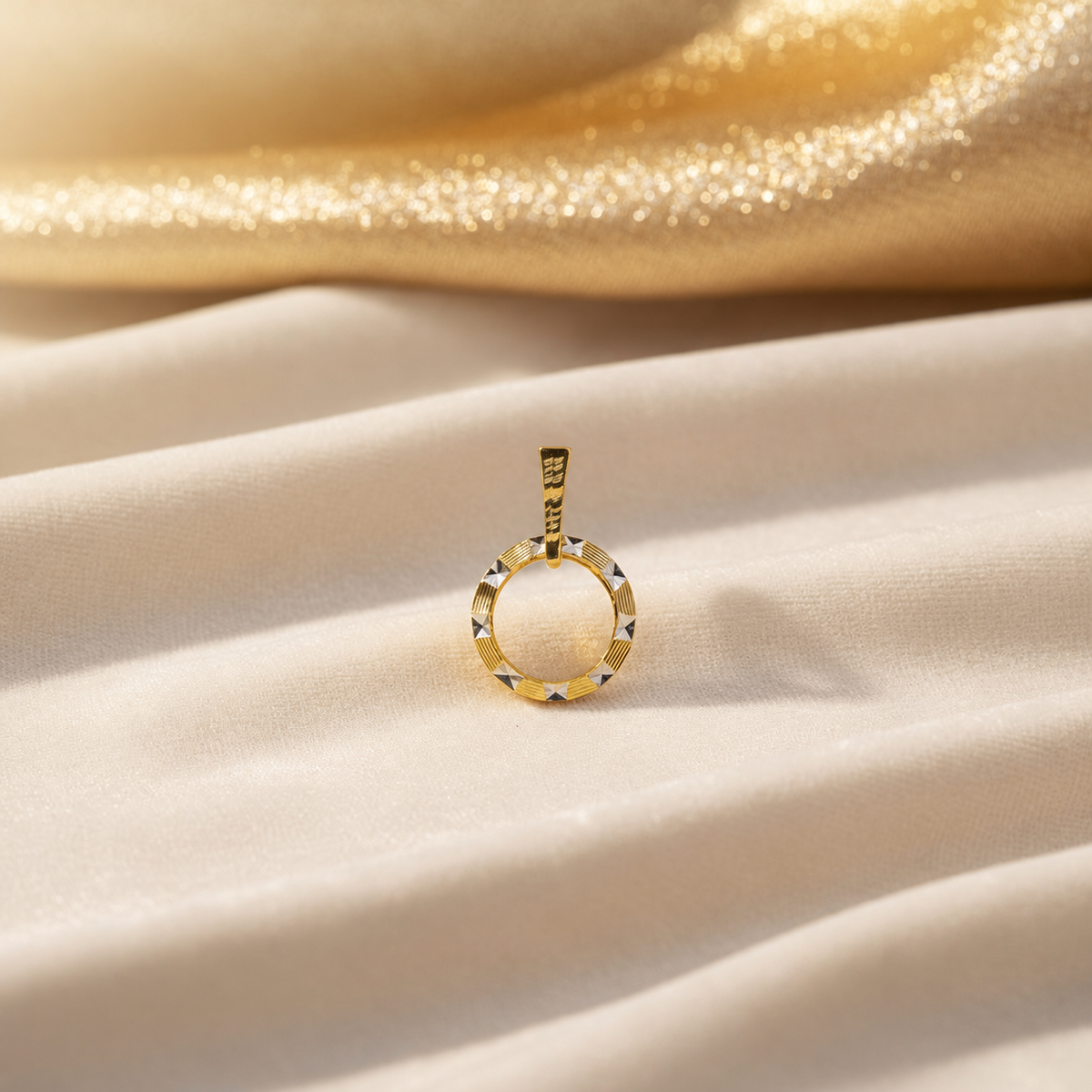 Reference circle pendant with alternating ribbed gold and bright faceted highlights on satin
