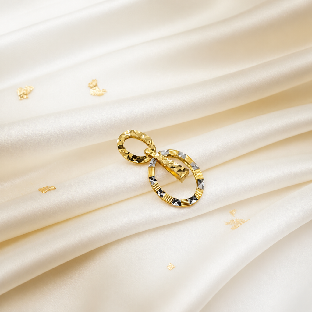 916 gold double-oval pendant angled on ivory satin with contrasting faceted highlights