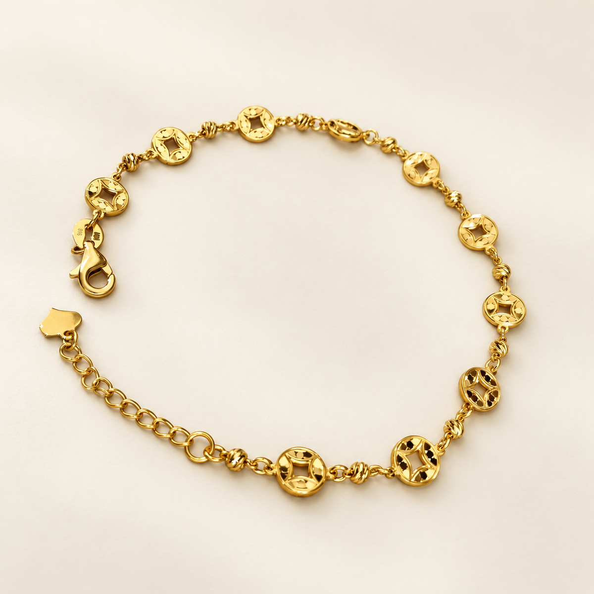 Angled view of the 22K gold Geometric Round Bracelet showing circular openwork motifs, spacer beads and lobster clasp