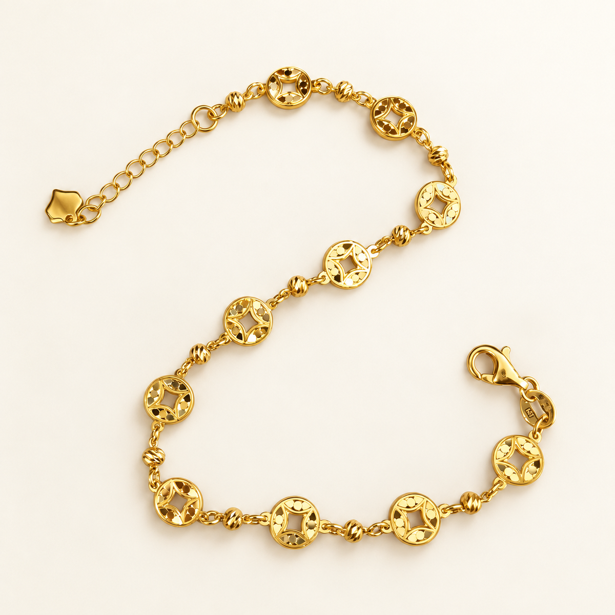 Full view of the 916 gold Geometric Round Bracelet with circular openwork motifs, textured spacer beads and adjustable chain on ivory