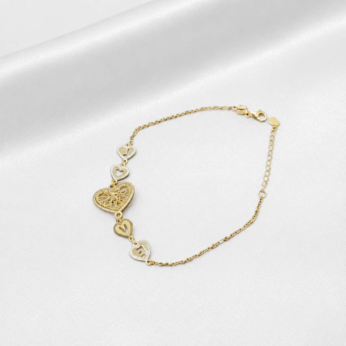 Angled view of BR20620 22K gold Golden Heart Chain Bracelet with filigree centre heart and smaller letter-heart links