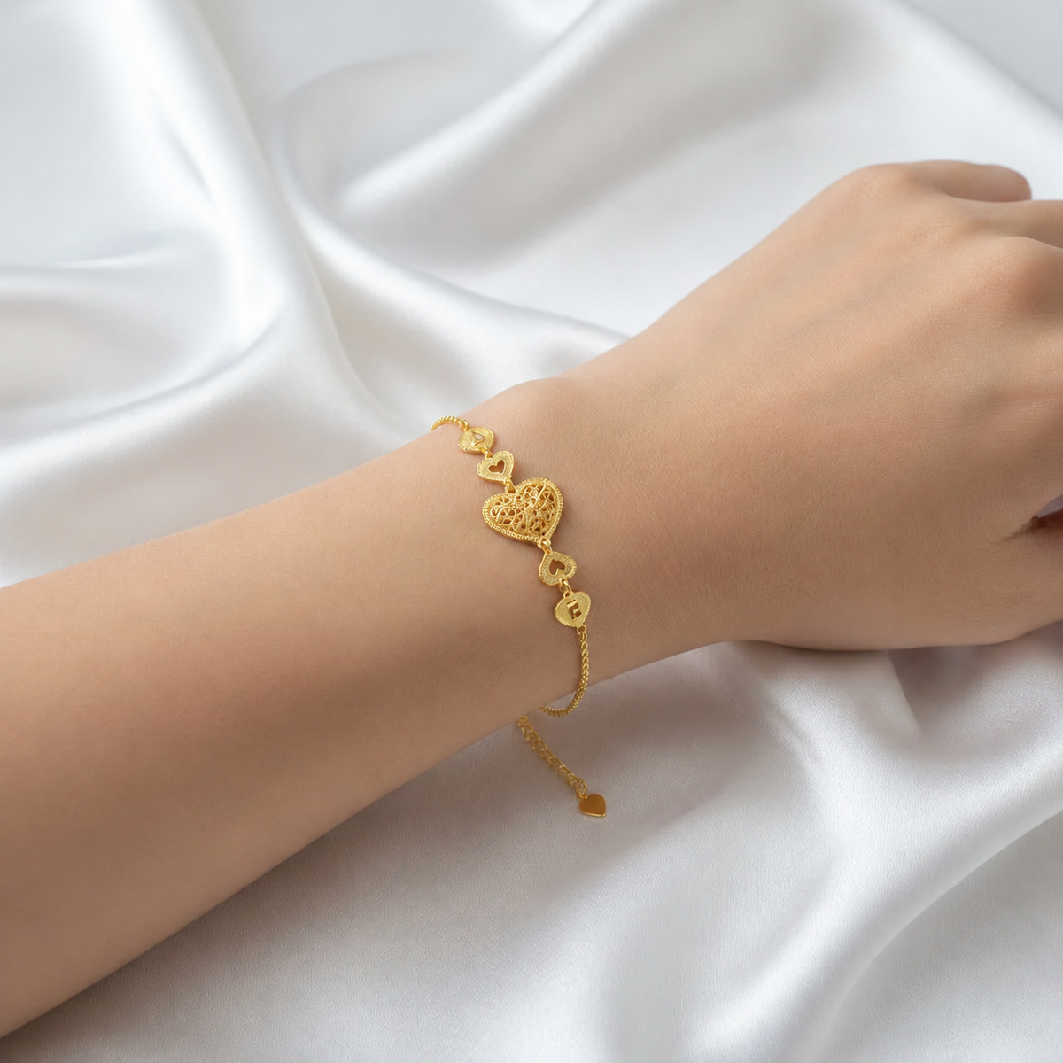 916 gold Golden Heart Chain Bracelet worn on a wrist, showing filigree heart and heart-tipped extension chain