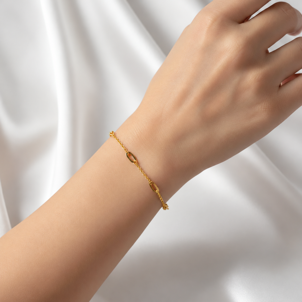 Guild Bullion 22K gold Golden Link Charm Bracelet worn on a wrist, showing spaced open links and fine chain sections