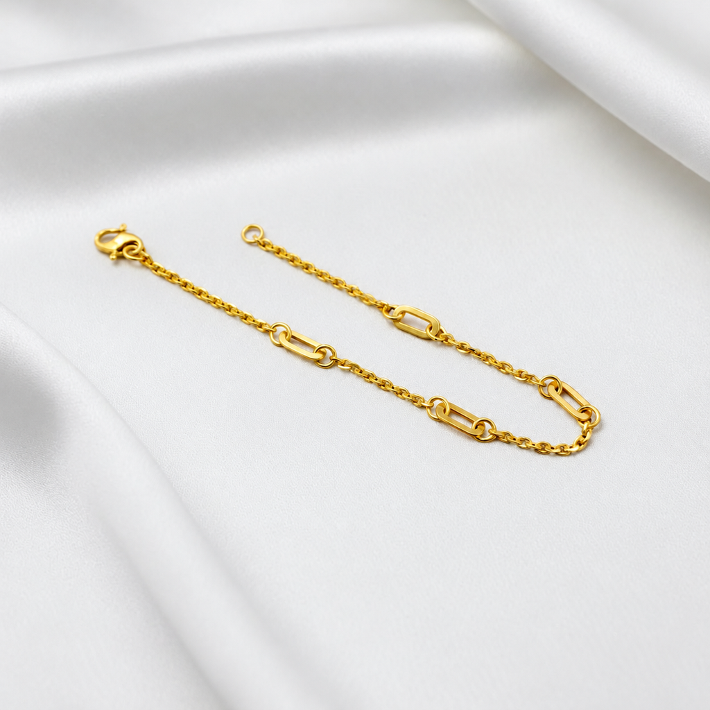 Angled view of the 22K gold Golden Link Charm Bracelet showing polished open links and fine chain sections