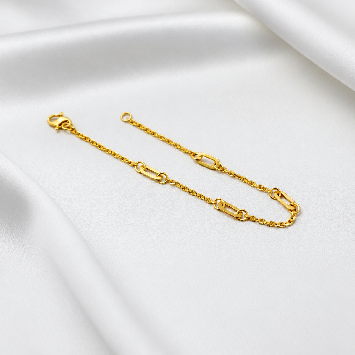 Angled view of the 22K gold Golden Link Charm Bracelet showing polished open links and fine chain sections