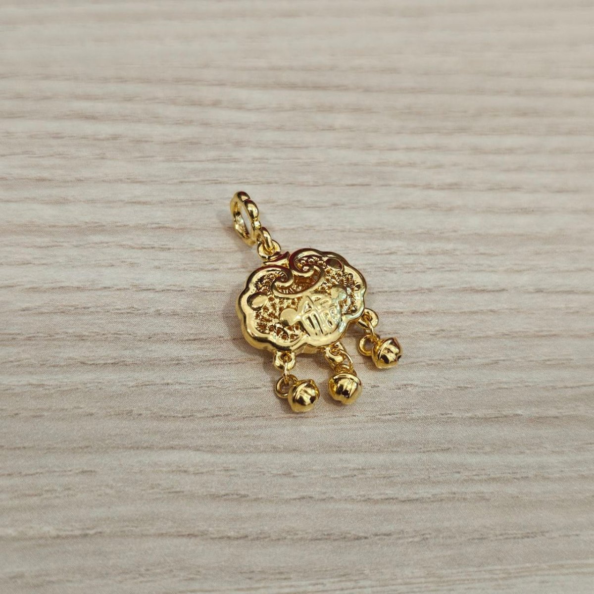 Guild Bullion 916 gold auspicious plaque with three dangles; collection design reference. Check selector for current options and availability.