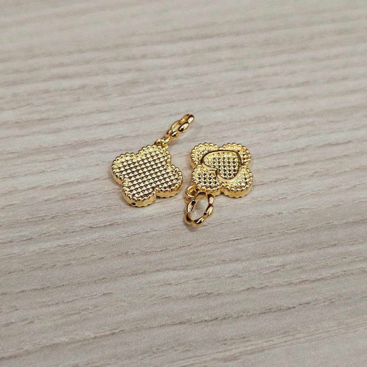 Guild Bullion 916 gold textured clover pair; collection design reference. Check selector for current options and availability.