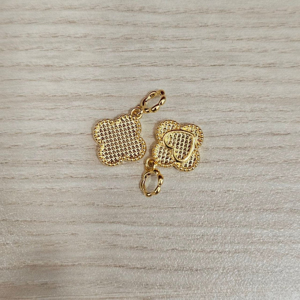 Guild Bullion 916 gold textured clover pair; collection design reference. Check selector for current options and availability.