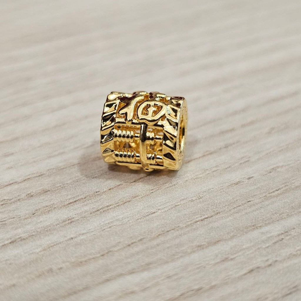 Guild Bullion 916 gold square character bead; collection design reference. Check selector for current options and availability.