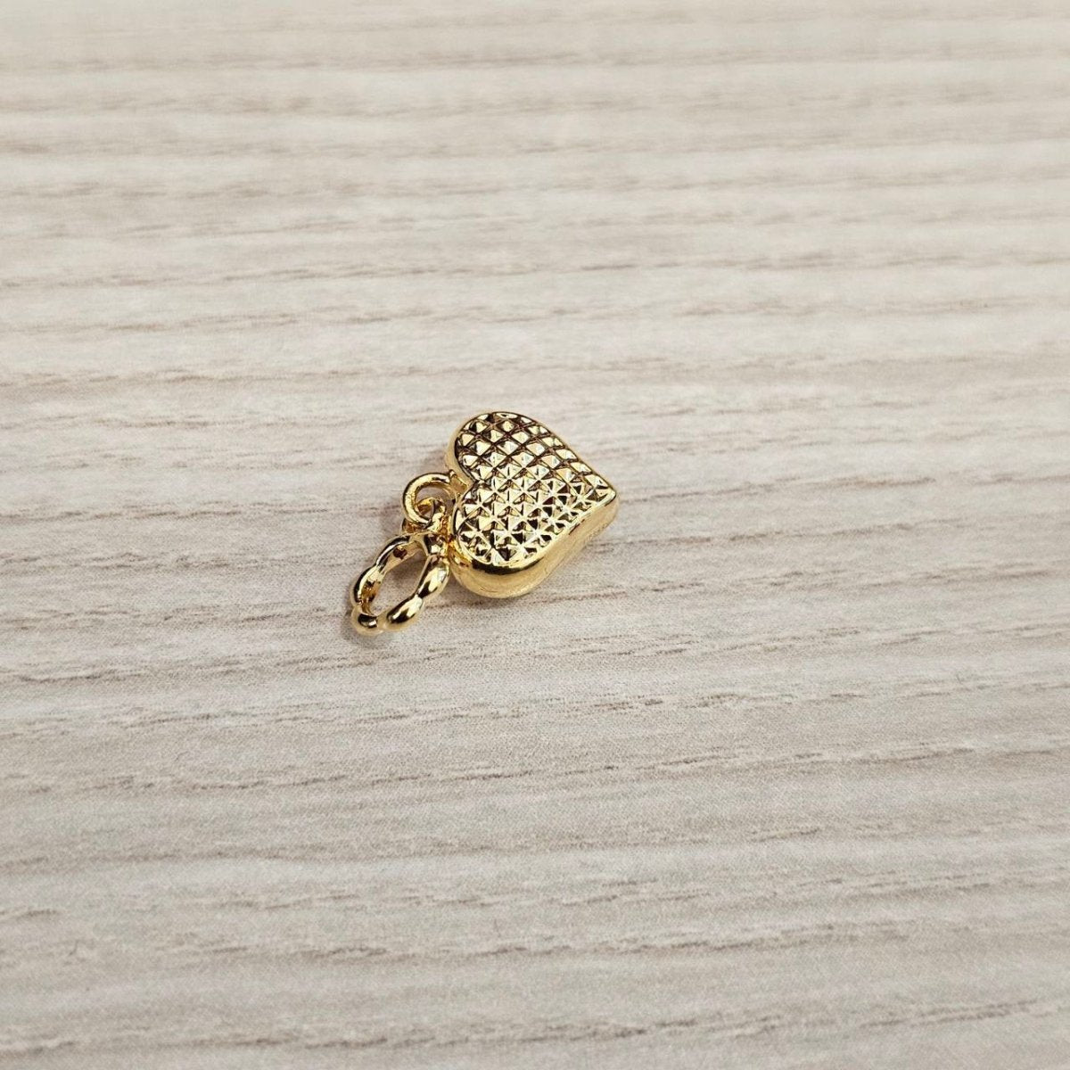 Guild Bullion 916 gold heart charm; collection design reference. Check selector for current options and availability.