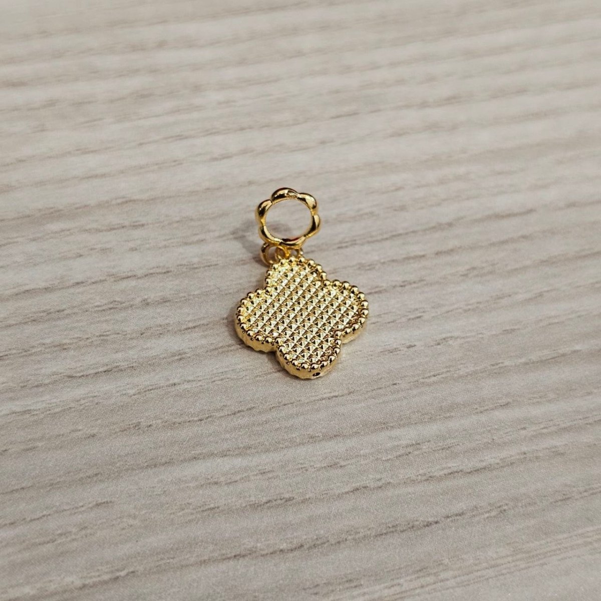 Guild Bullion 916 gold clover charm; collection design reference. Check selector for current options and availability.
