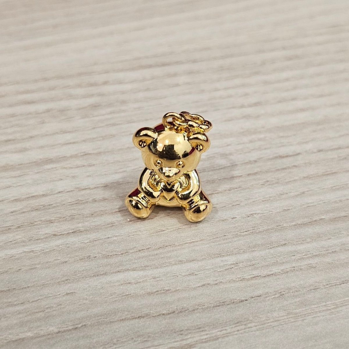 Guild Bullion 916 gold teddy bear charm; collection design reference. Check selector for current options and availability.