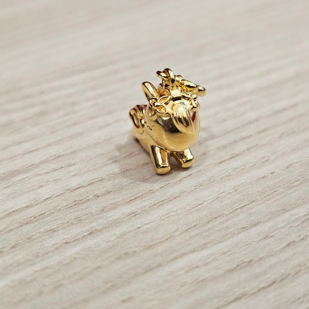 Guild Bullion 916 gold animal figure charm; collection design reference. Check selector for current options and availability.