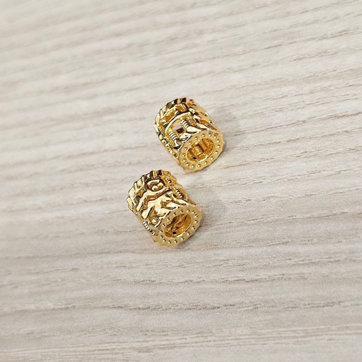 Guild Bullion 916 gold barrel bead pair; collection design reference. Check selector for current options and availability.