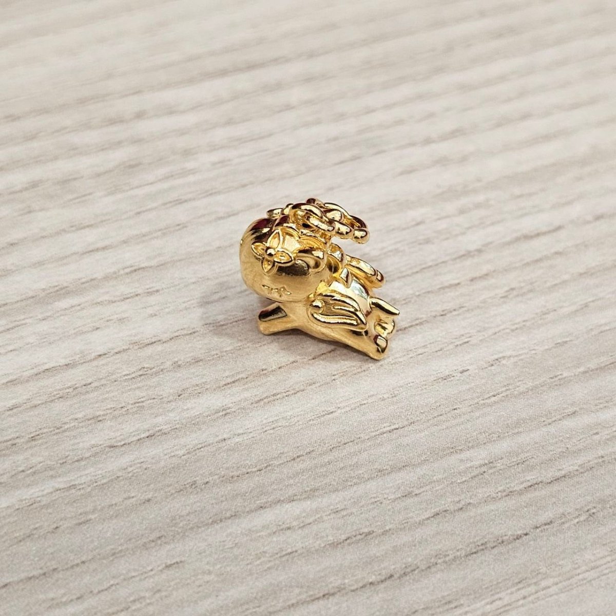 Guild Bullion 916 gold small animal charm; collection design reference. Check selector for current options and availability.