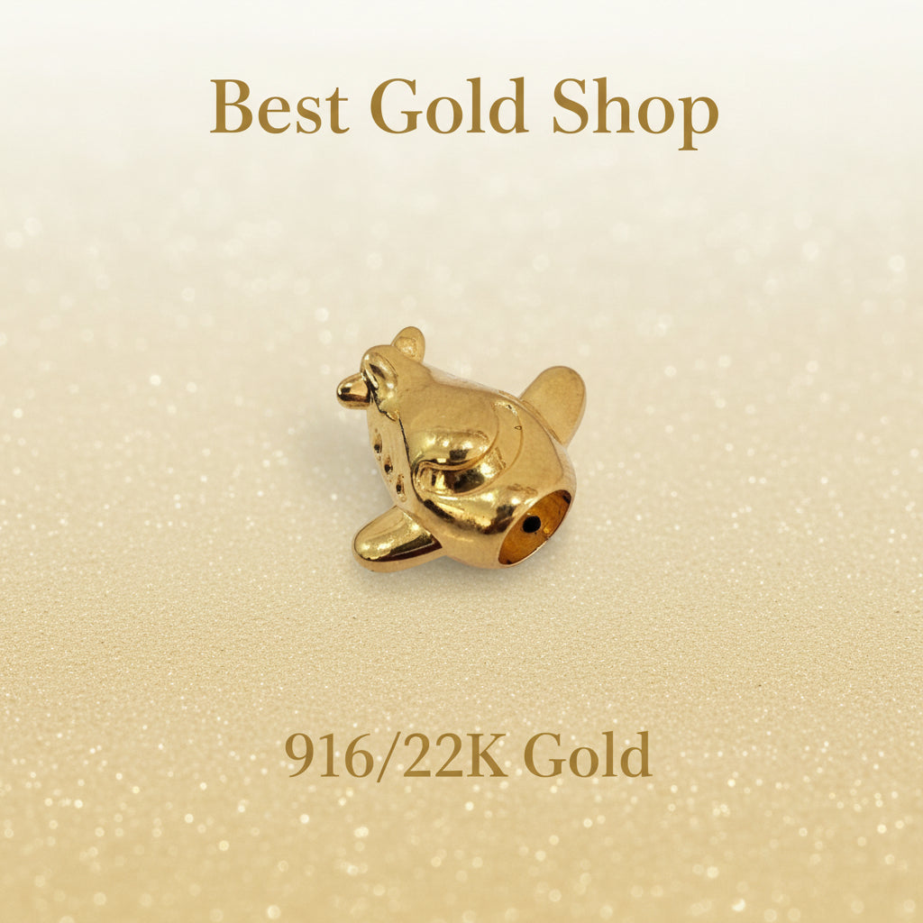 Guild Bullion 916 gold airplane charm; collection design reference. Check selector for current options and availability.