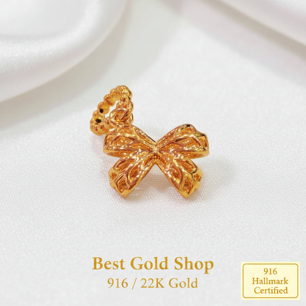 Guild Bullion 916 gold bow charm; collection design reference. Check selector for current options and availability.