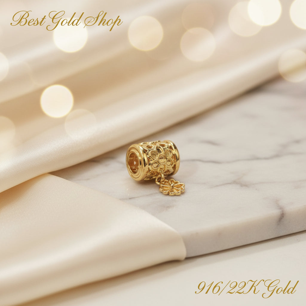 Guild Bullion 916 gold barrel bead with flower; collection design reference. Check selector for current options and availability.