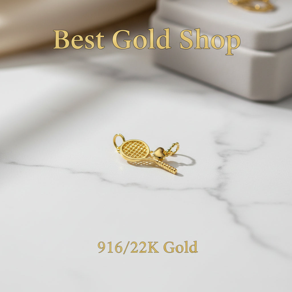 Guild Bullion 916 gold racket charm; collection design reference. Check selector for current options and availability.