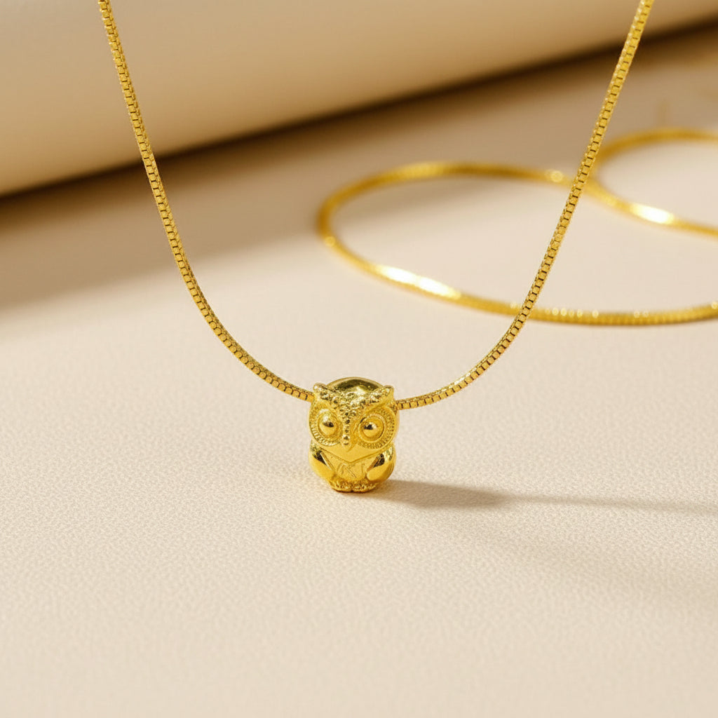 Guild Bullion 916 gold owl bead displayed on chain; collection design reference. Check selector for current options and availability.