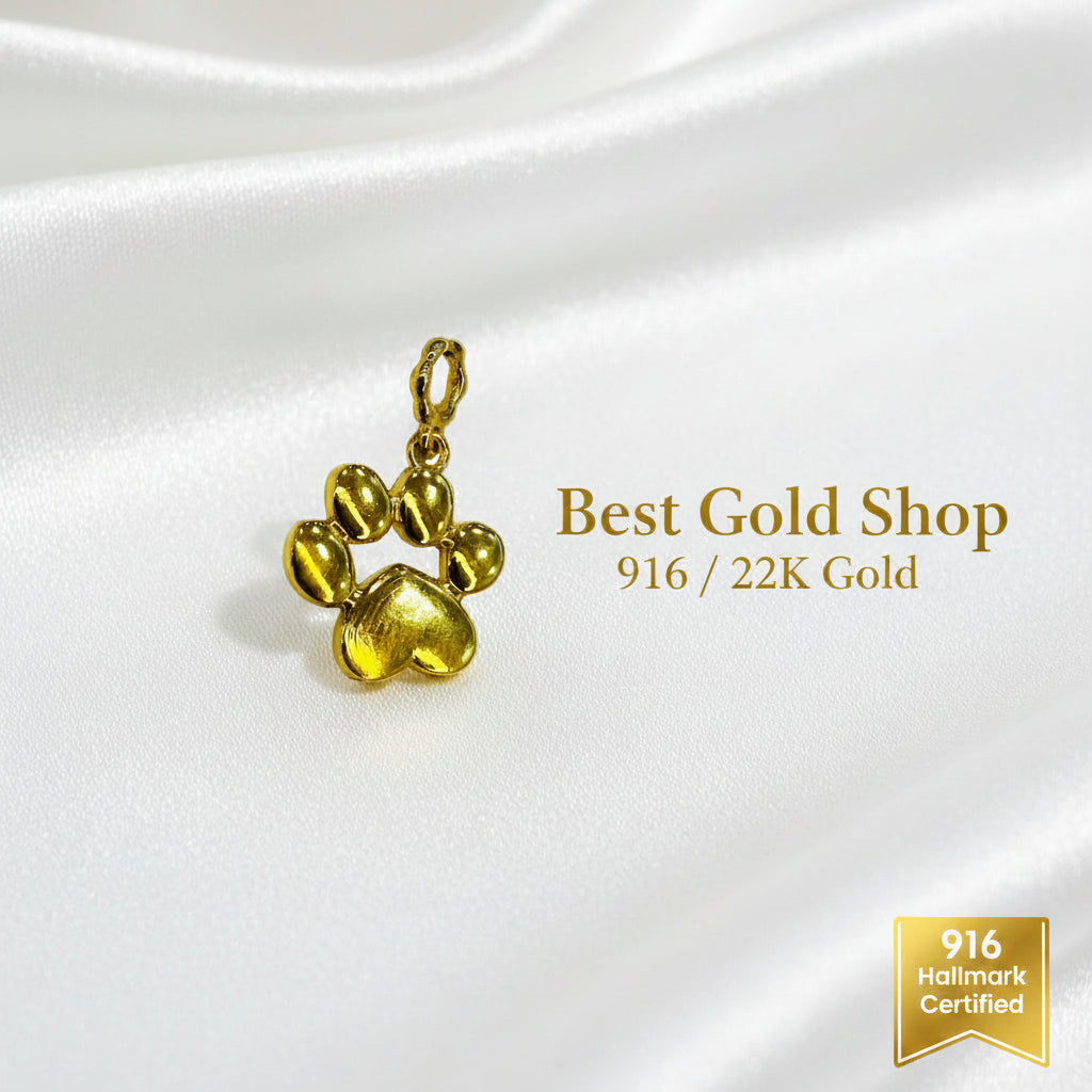 Guild Bullion 916 gold paw print charm; collection design reference. Check selector for current options and availability.