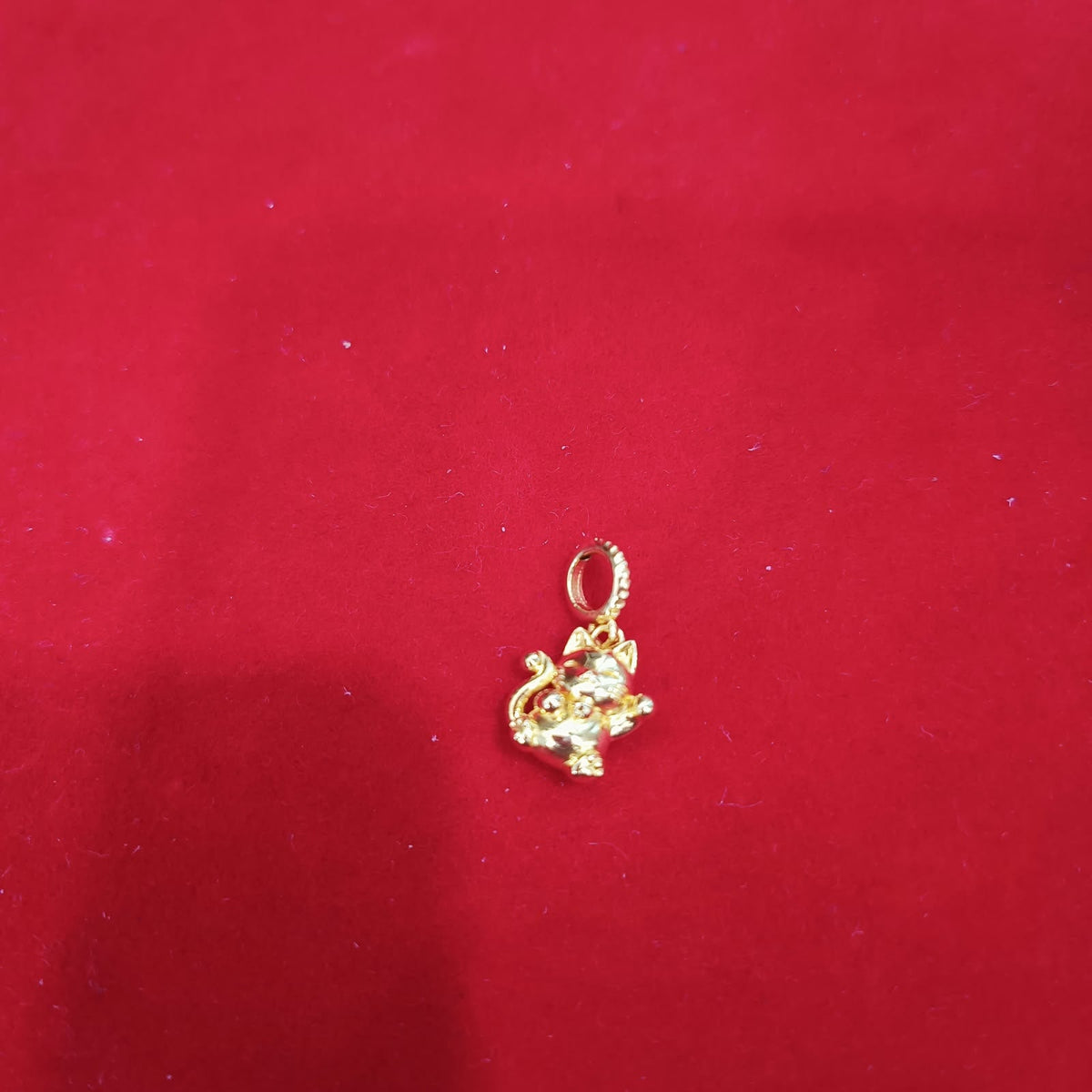 Guild Bullion 916 gold small figure charm on red background; collection design reference. Check selector for current options and availability.