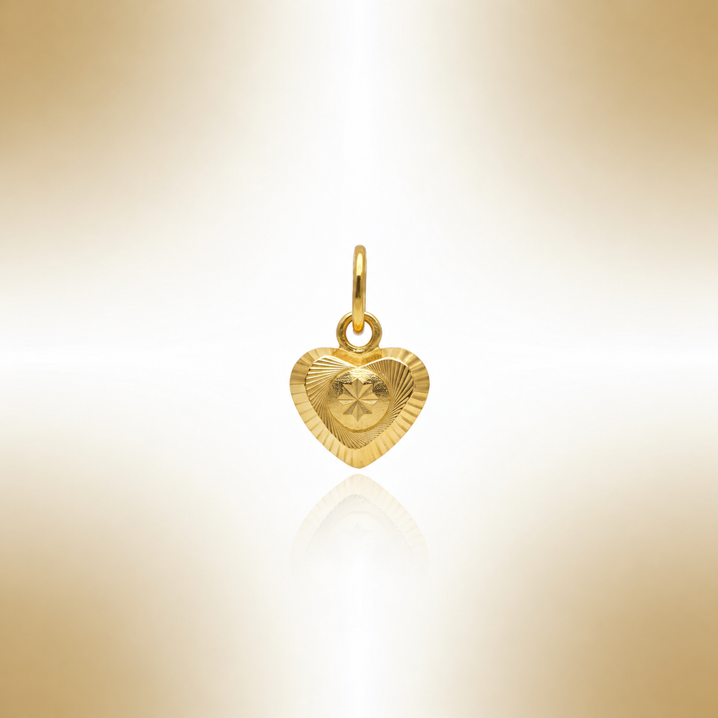 Reference view of a gold heart pendant with circular patterned centre and reflection