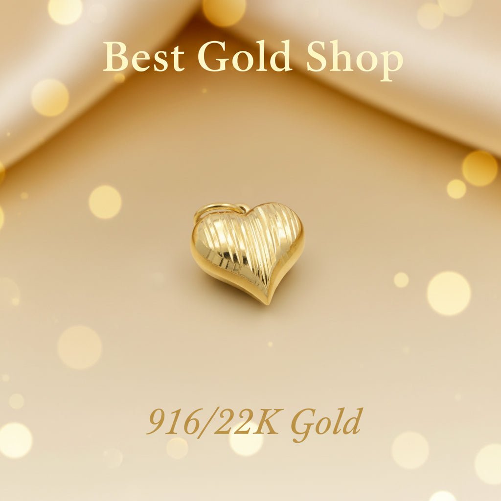 Angled view of 916 gold Heart Cot pendant PD23868 showing vertical grooves on a warm gold background