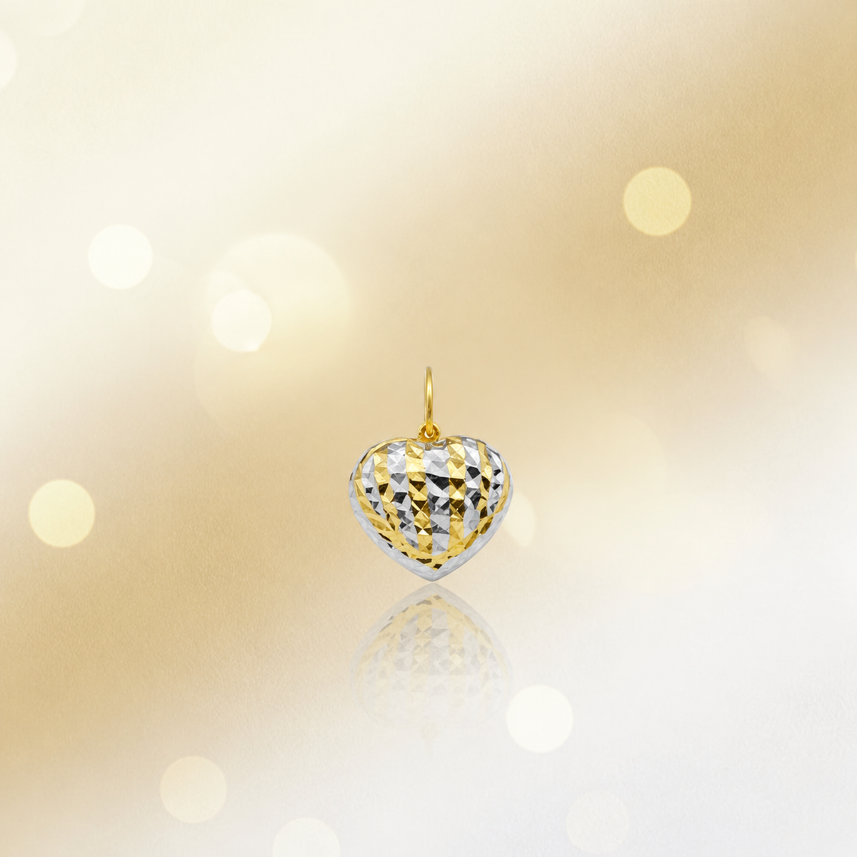 Front view of a two-tone 916 faceted heart pendant with reflection on cream