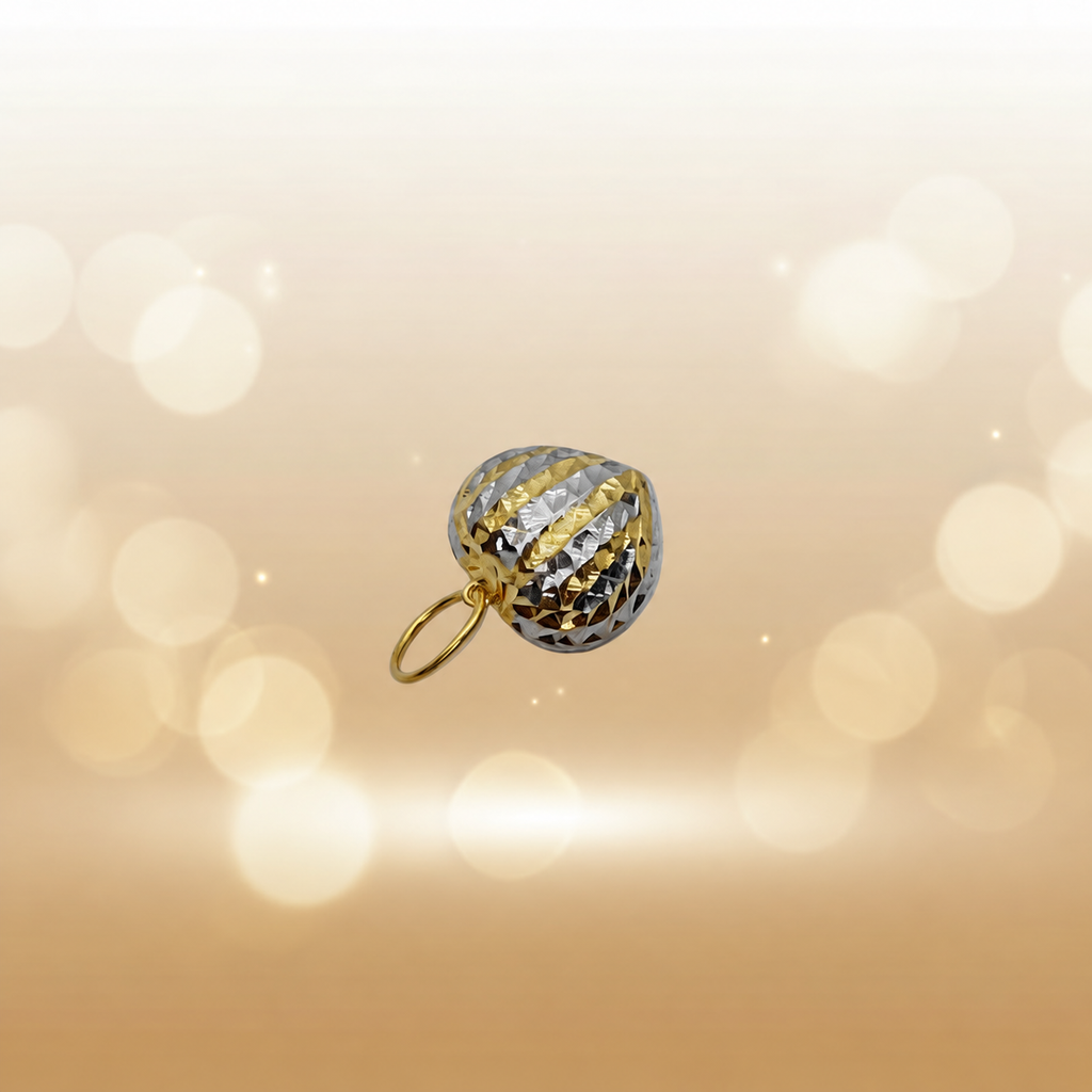 Angled view of a two-tone 916 faceted heart pendant against a cream bokeh background