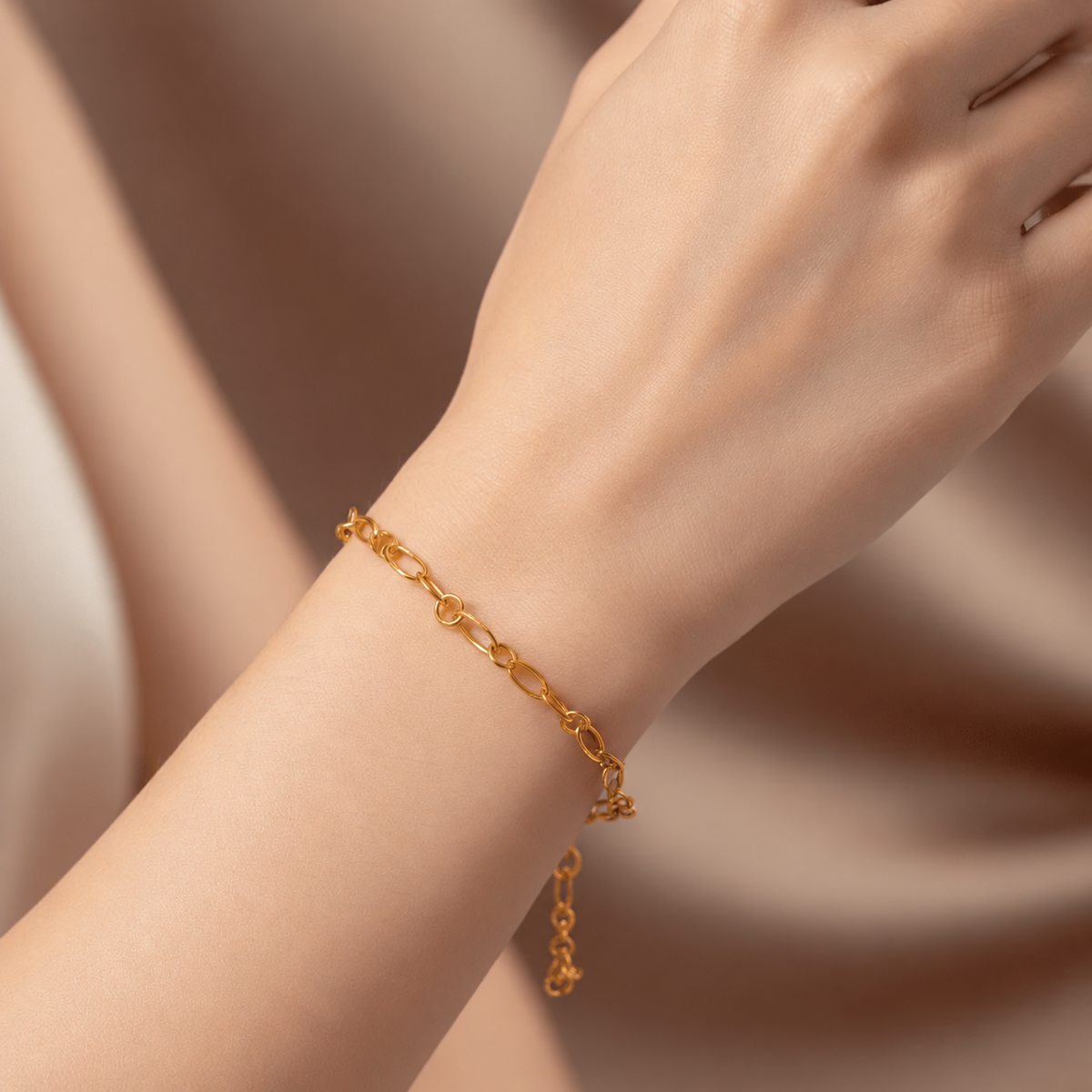 Guild Bullion 22K gold lightweight link bracelet worn on the wrist with extension rings visible
