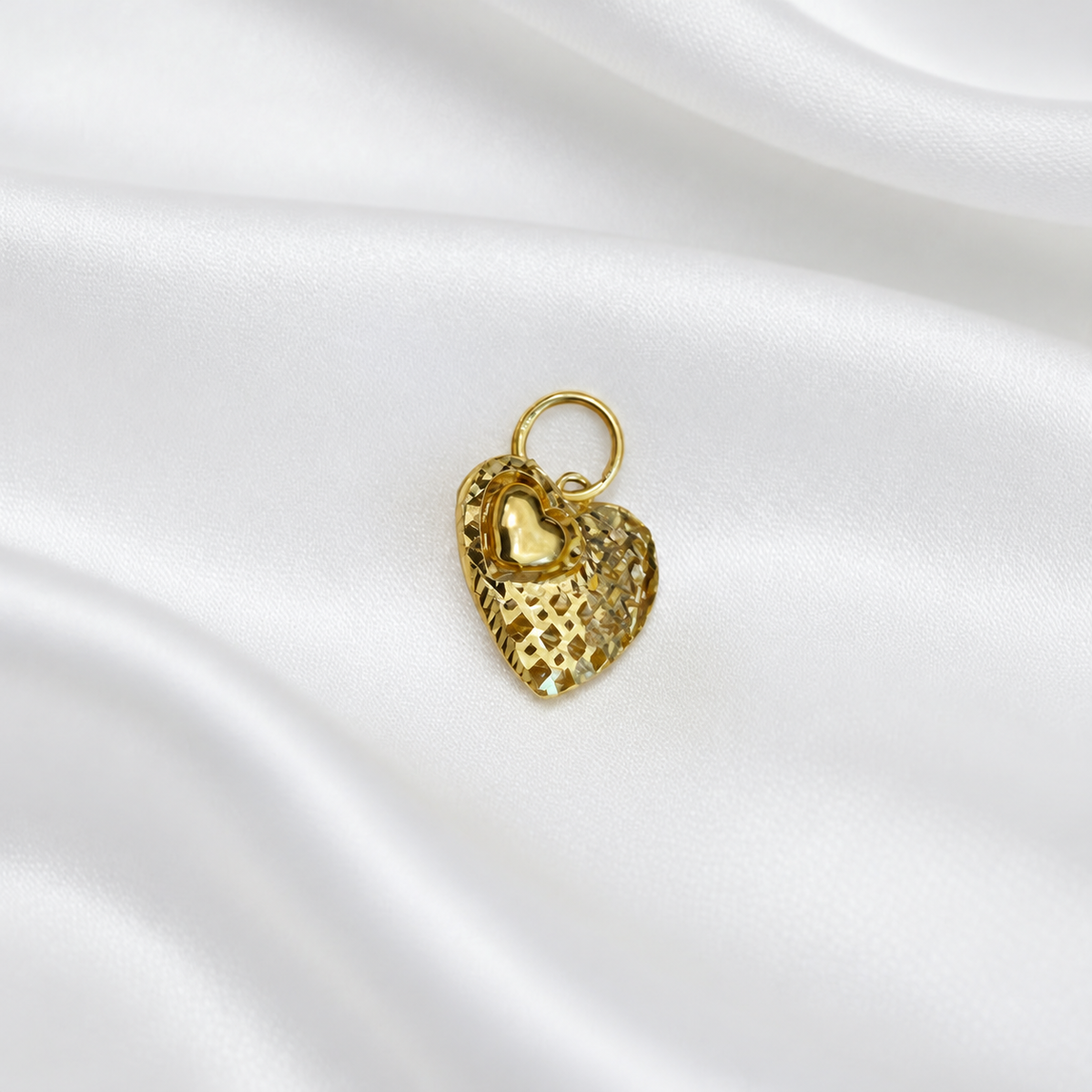 Side angle of the 916 gold heart pendant with mini-heart accent and round hanging loop