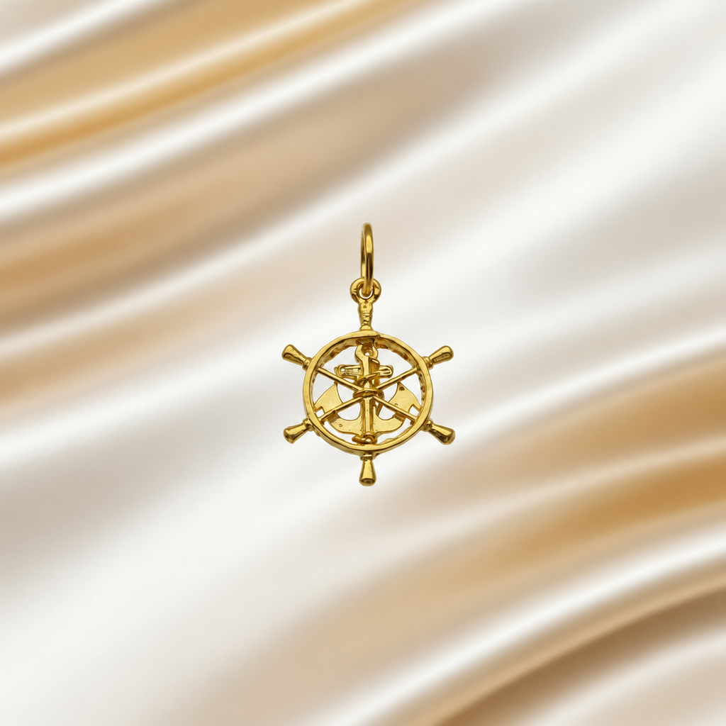 916 gold openwork ship’s-wheel pendant with anchor motif on ivory satin