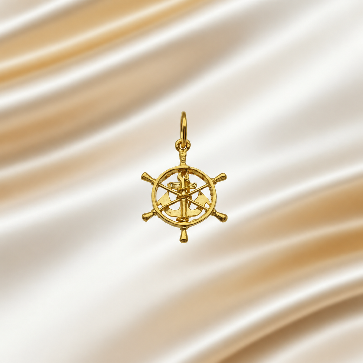916 gold openwork ship’s-wheel pendant with anchor motif on ivory satin