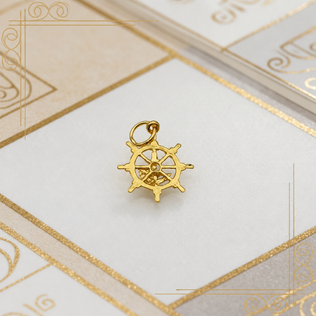 Reverse view of the 916 gold openwork nautical pendant showing spokes and bail