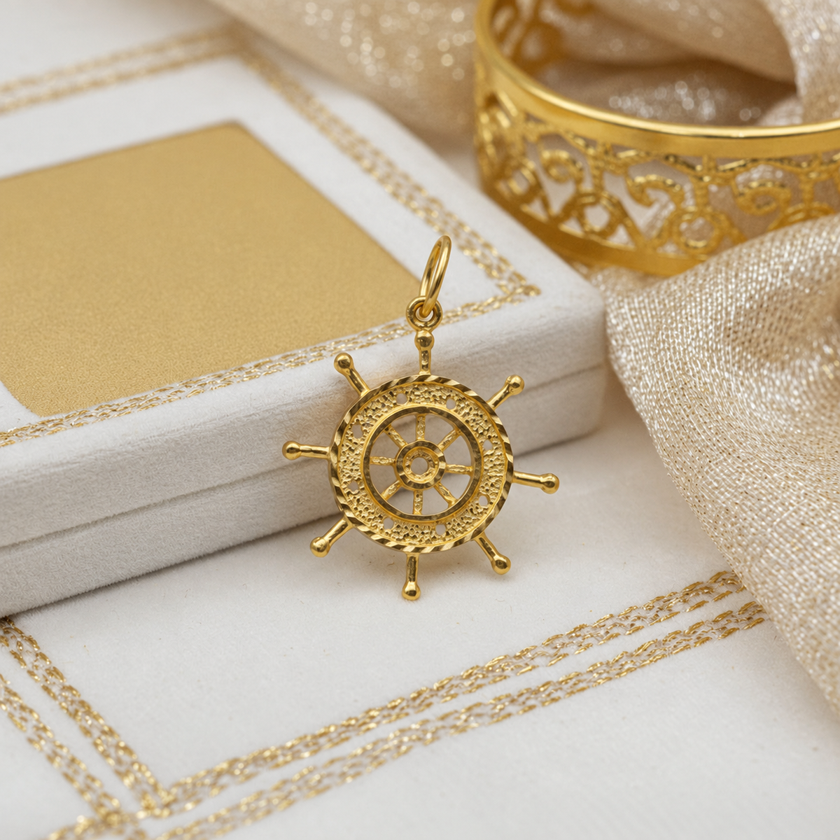 916 gold ship’s-wheel pendant with textured rim and eight projecting handles