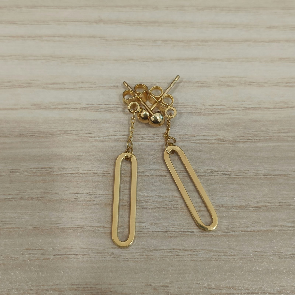 Front view of 916 gold paperclip dangle earrings ER30015 showing polished open links and rounded stud tops