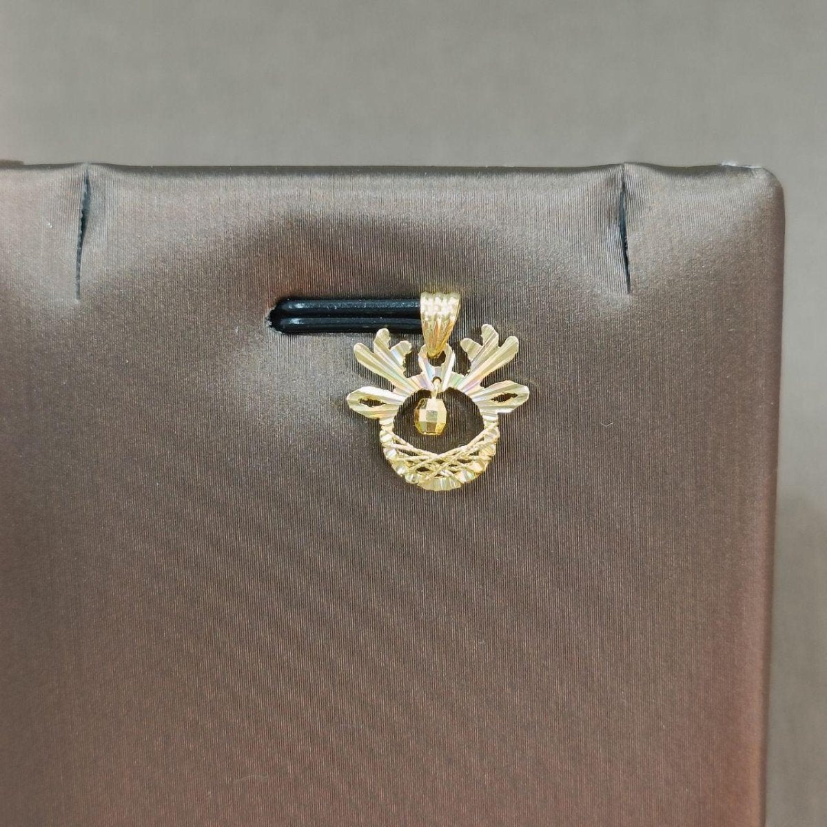 Alternate view of the reference gold antler-shaped pendant and dangling bead