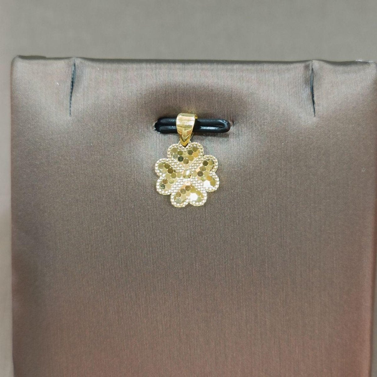 Reference gold flower-shaped pendant with open circular details