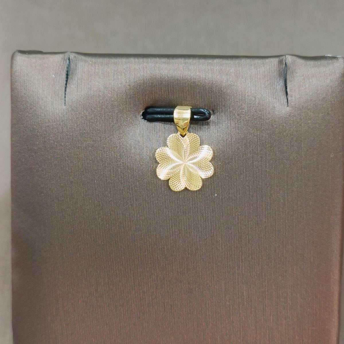 Reverse of the reference gold flower pendant showing textured petals