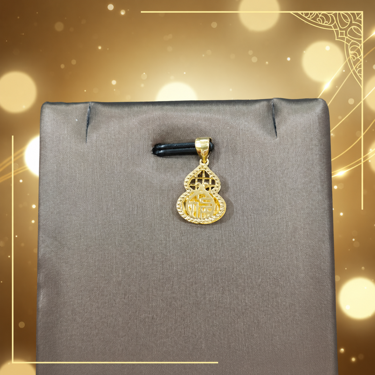 Reference gourd-shaped gold pendant with Chinese character detail on a grey display against gold bokeh