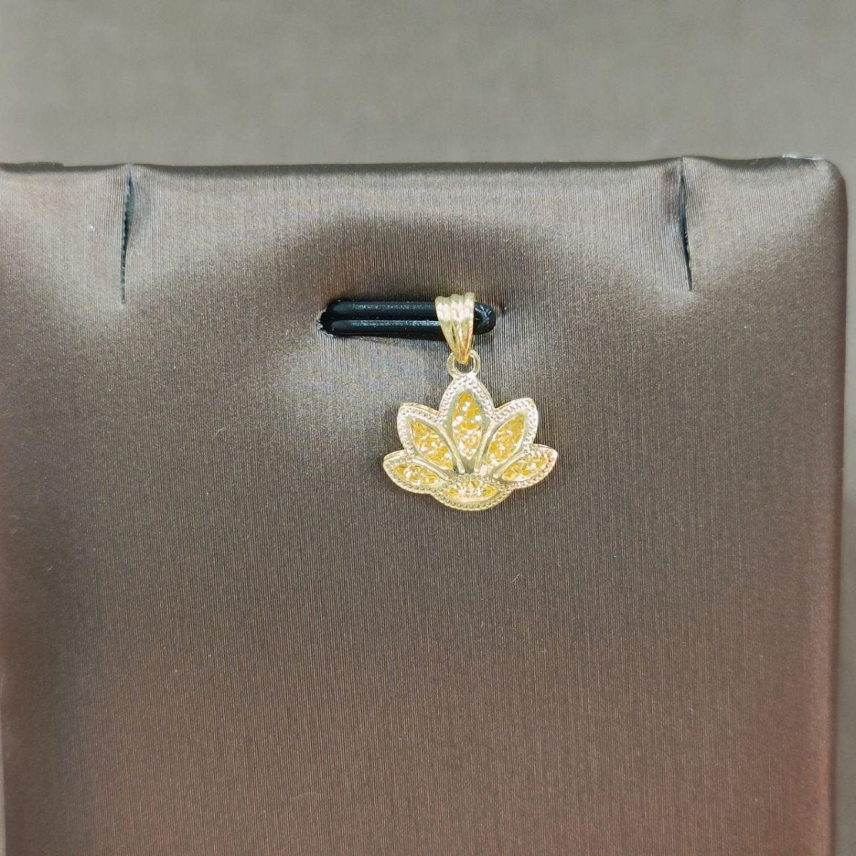 916 gold lotus flower pendant with detailed petal borders on a grey display