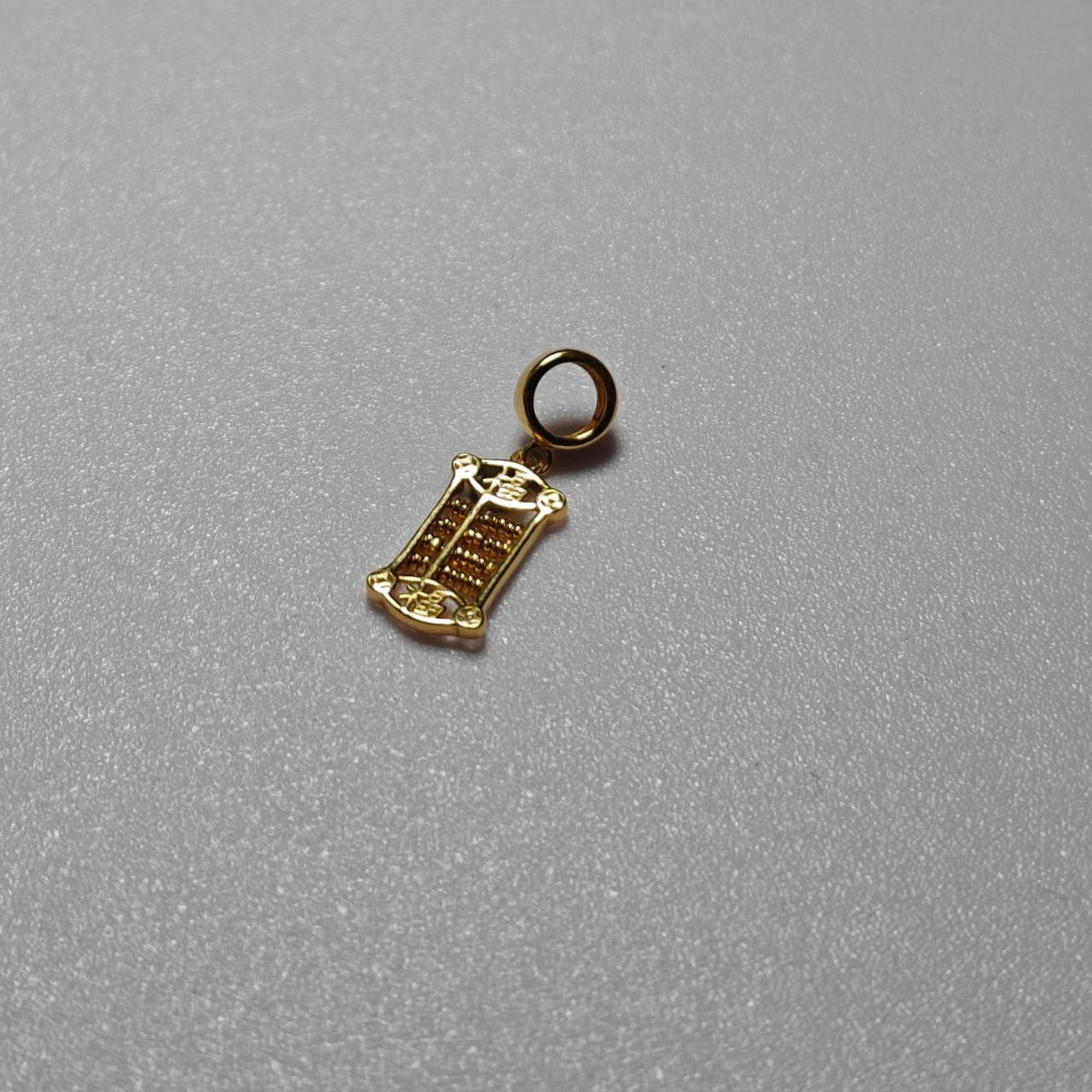 Front view of the 916 gold prosperity abacus pendant showing bead rows, end-panel motifs and oval loop