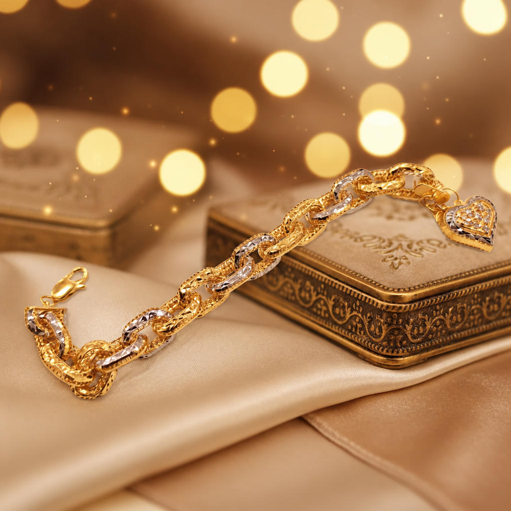 916 gold Regal Link Bracelet with two-tone links and heart charm draped beside a decorative jewellery box