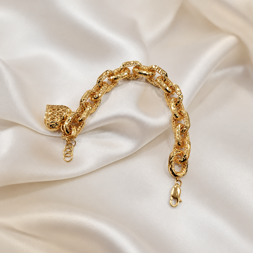 Reverse of the 916 gold Regal Link Heart Charm Bracelet showing gold link detailing, clasp and extension rings on satin
