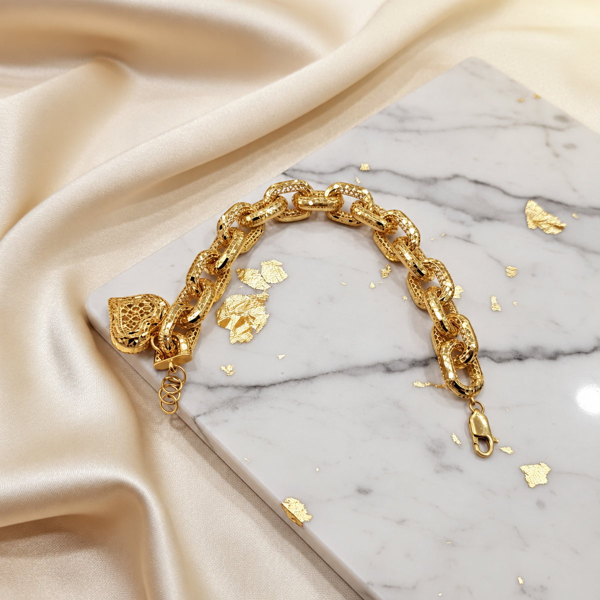 Reverse view of the 22K gold Regal Link Heart Charm Bracelet on pale marble with clasp and extension rings
